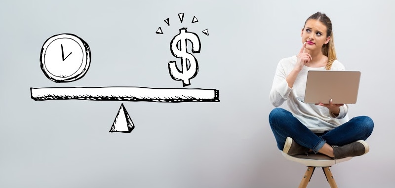 A woman sitting on a chair with a laptop, looking thoughtfully at a drawing of a scale balancing a clock and a dollar sign.