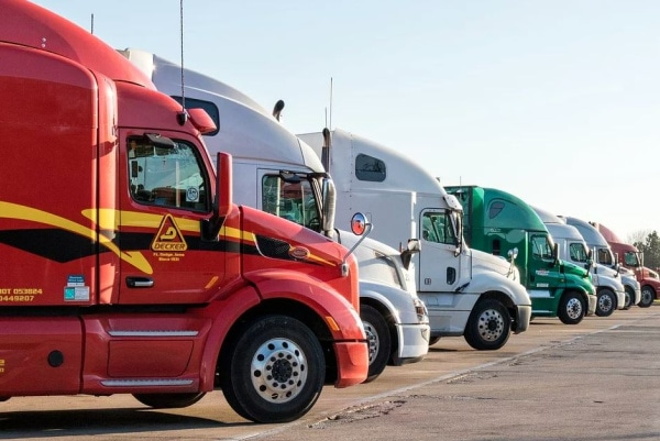 Various semi trucks parked in a line