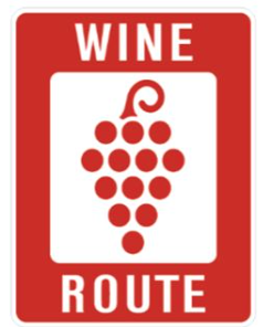 A purple grapes symbol on a white background, used for marking wine routes.