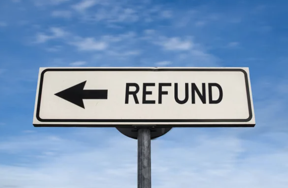 a road sign with a black error and the word Refund.