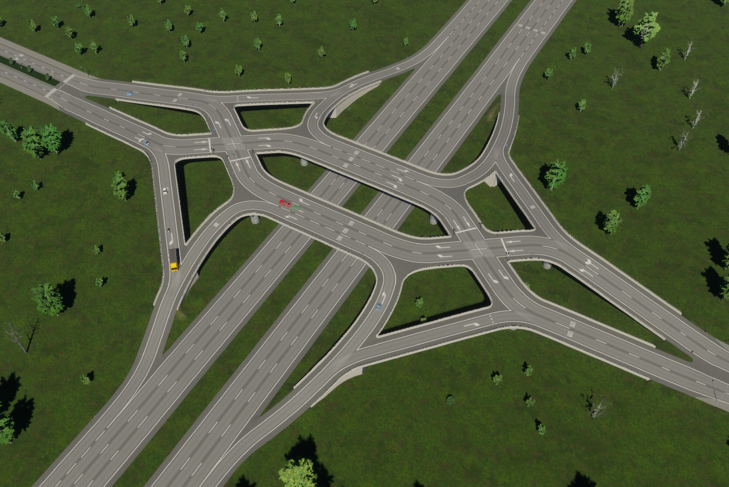 Aerial view of a diverging diamond interchange with intersecting highways surrounded by green fields and trees.